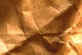 Aged crumpled paper texture brown color. Close up