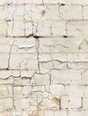 An aged and dilapidated brick wall with crumbling white paint, showcasing the weathered and textured surface caused by Royalty Free Stock Photo