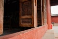 Aged door leaves with woodcarving of ancient Chinese building