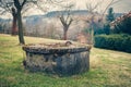 Aged Garden Water Well Covered by Lichen and Moss Royalty Free Stock Photo