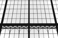 Aged glass and metallic building facade in black and white