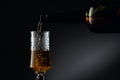 Aged golden fortified wine from the vintage bottle being poured into a crystal glass Royalty Free Stock Photo