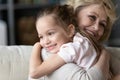 Aged grandmother caresses beloved granddaughter hugs her closeup view