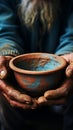 Aged hands clutch empty bowl, selective focus conveying the harshness of poverty Royalty Free Stock Photo