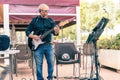 Aged happy musician performing in the terrace of a restaurant Royalty Free Stock Photo