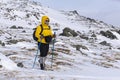 Aged woman is engaged in trekking in winter highlands