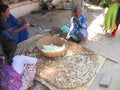 Aged Indian women making silk with their hands