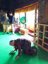 A aged ladhaki woman paying at the Shey Palace temple