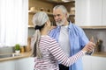 Aged Love. Portrait Of Romantic Elderly Spouses Dancing In Kitchen Interior Royalty Free Stock Photo