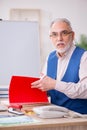 Old male designer working in the office Royalty Free Stock Photo