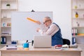 Old male designer working in the office Royalty Free Stock Photo