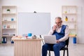 Old male designer working in the office Royalty Free Stock Photo