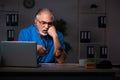 Aged male doctor in the hospital at night