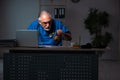 Aged male doctor in the hospital at night