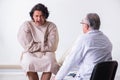 Aged male doctor psychiatrist examining young patient Royalty Free Stock Photo