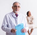 Aged male doctor psychiatrist examining young patient Royalty Free Stock Photo