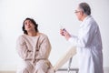 Aged male doctor psychiatrist examining young patient Royalty Free Stock Photo