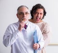 Aged male doctor psychiatrist examining young patient Royalty Free Stock Photo