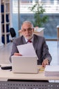 Aged businessman employee working in the office Royalty Free Stock Photo