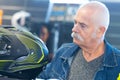 aged man buying motorcycle helmet