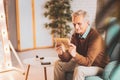 Aged man feeling momentous looking photos