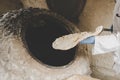 Hot bread. Central Asian cuisine. aged man makes traditional bread in old round stone oven in rural village Royalty Free Stock Photo