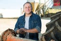 Aged man on small farm tractor Royalty Free Stock Photo