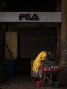 Aged man street vendor preparing, selling Indian betel leaf and Areca nut masala paan, tobacco and other snacks from his stall