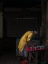 Aged man street vendor preparing, selling Indian betel leaf and Areca nut masala paan, tobacco and other snacks from his stall