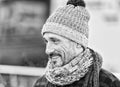 Aged man in winter hat and scarf. Portrait of smiling guy on street. Guy in knitted scarf and hat Royalty Free Stock Photo