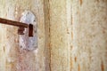 Aged metal door handle with an old-style key attached to it Royalty Free Stock Photo