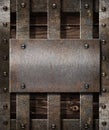 Aged metal plate on wooden medieval background Royalty Free Stock Photo