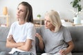 Aged mom lecturing adult daughter sitting at home together Royalty Free Stock Photo