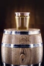 Aged oak barrel with glass of distilled beverage used for fermented drinks such as rum, cachaÃÂ§a, vodka, among others. Spot focus