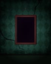 Aged old room with green grunge wallpaper and hanging empty picture frame Royalty Free Stock Photo