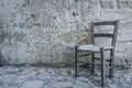Aged old traditional chair in empty stone room in ancient ghost