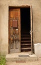 Aged dark wooden door in weathered concrete wall Royalty Free Stock Photo