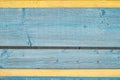 Aged painted cracked boards with blue and yellow color peeling paint. Old natural grunge textured wooden texture. Weathered wood w Royalty Free Stock Photo