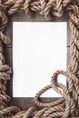 Aged paper with rope frame on old wood background Royalty Free Stock Photo