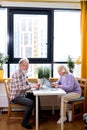 Aged People Using Laptop Working Or Studying At Home, Websurfing In Cozy Room. Royalty Free Stock Photo