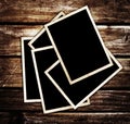 Aged photo frames on wood background Royalty Free Stock Photo