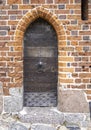 Aged planks with old rivets, bolts, door handle. The gothic door in the medieval teutonic knights castle Malbork, Poland. Royalty Free Stock Photo