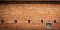 Aged red brick wall with windows background, Chiang Mai old city wall gate, Thailand