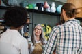 Aged saleswoman consulting multiracial couple at decor store