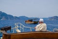 An aged senior man on a luxurious yacht boat looking at the blue sea. ocean vacation transport. marine boat trip. rich
