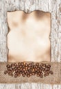 Aged sheet of paper with coffee beans and burlap ribbon