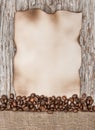 Aged sheet of paper with coffee beans on the old wood