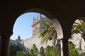 Spanish architecture. View through the arches of the palace. on palms garden in a sunny day Royalty Free Stock Photo