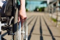 Aged strong lady rolling the wheelchair