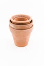 aged terracotta flowerpots on a white surface